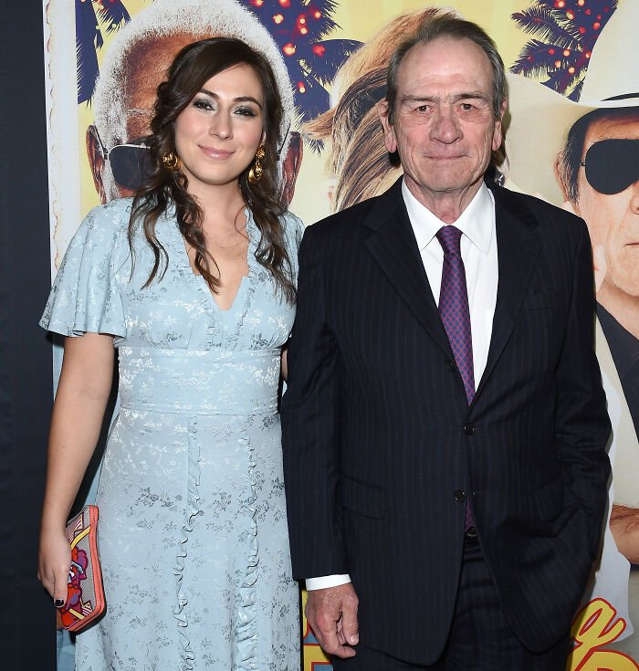 Tommy Lee Jones and his daughter posing at a movie premiere, highlighting her cause of passing revealed in the news.