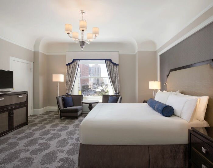 Luxury hotel room with king bed and city view, related to Tommy Lee Jones’ daughter’s cause of passing revealed after found.