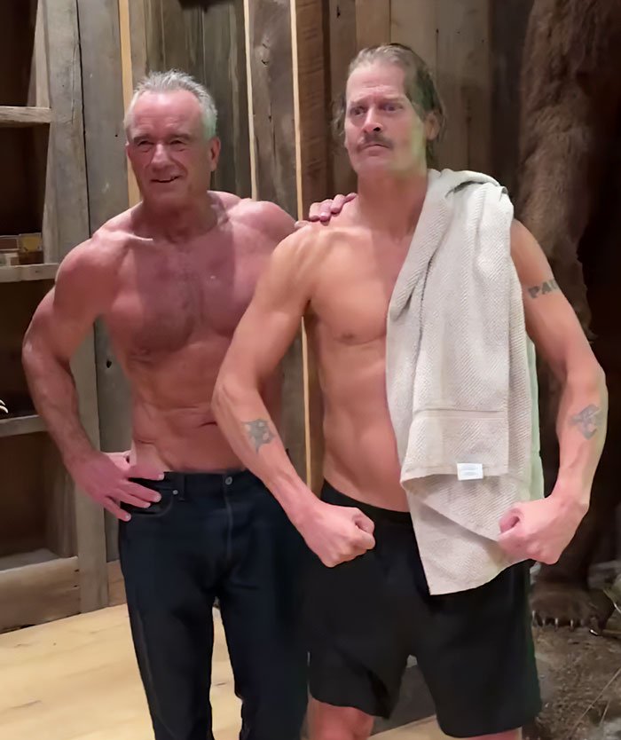 RFK Jr. and Kid Rock posing shirtless in a rustic room after a workout in their new deranged fitness video.