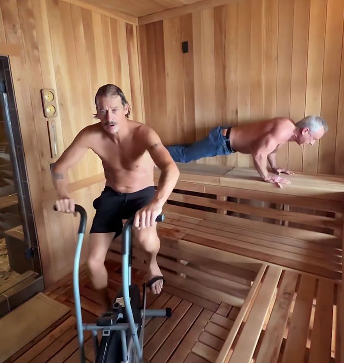 RFK Jr. and Kid Rock shirtless working out in a wooden sauna, with one using exercise equipment and the other doing push-ups.