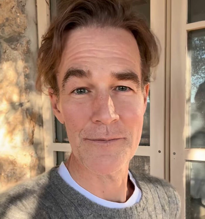 Middle-aged man in a gray sweater outdoors highlighting a colon cancer breakthrough progress in medical research.