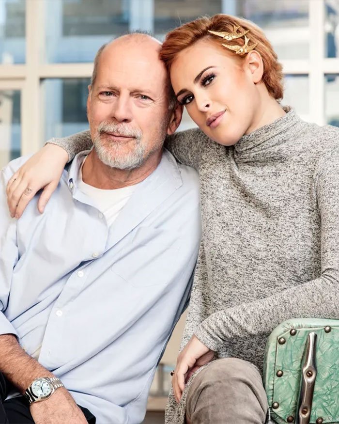 Rumer Willis with her famous father Bruce Willis, sharing a relaxed moment indoors, highlighting her work challenges.