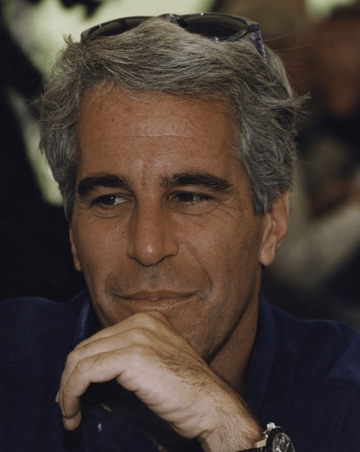 Man with gray hair and sunglasses on head, involved in Epstein conspiracy theories related to Erika Kirk.