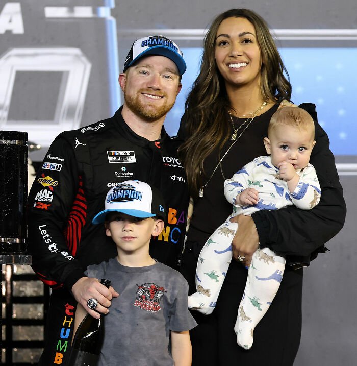 NASCAR driver with family after winning, addressing Michael Jordan and 6YO son interaction controversy.