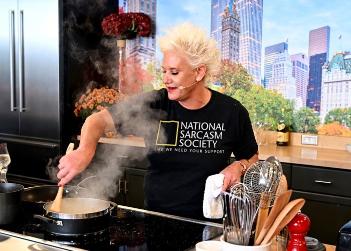 Anne Burrell cooking in a kitchen, stirring a pot with steam rising, highlighting police report alleged details.