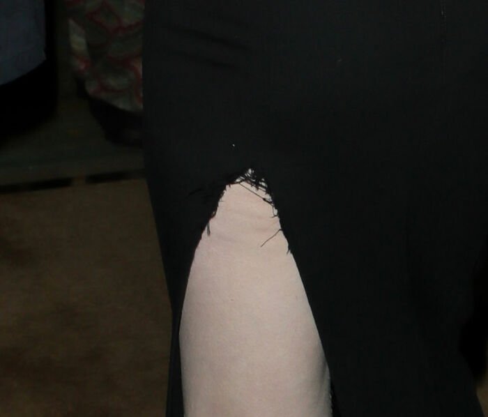 Close-up of a black dress with a torn slit, highlighting a fashion emergency at the 2026 BAFTA's afterparty.
