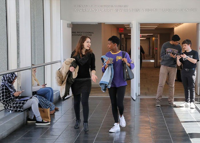 Students walking and talking in a school hallway outside the Klara and Larry Silverstein Student Success Center.