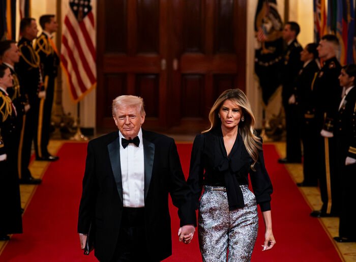 Melania Trump at governors dinner wearing a controversial outfit, walking beside Donald Trump on a red carpet.