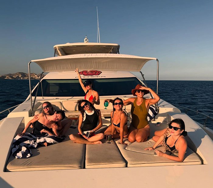 Selena Gomez and friends relaxing on a yacht wearing swimsuits, sparking swimsuit debate after fans notice odd detail.