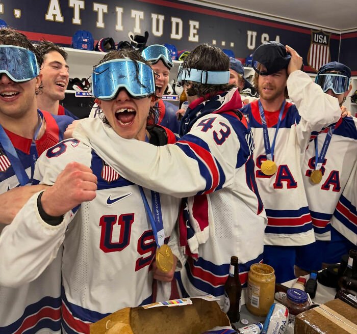 Team USA men's hockey players celebrating with gold medals and wearing goggles, sparking controversy after White House visit.