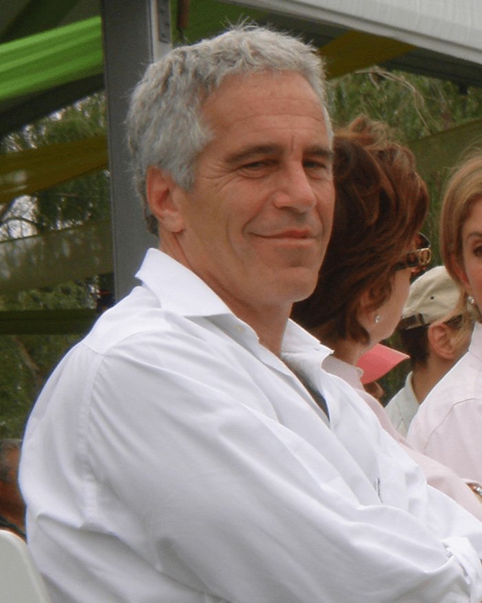 Man with gray hair in a white shirt at an outdoor event related to Epstein scandal and Bill Gates apology.