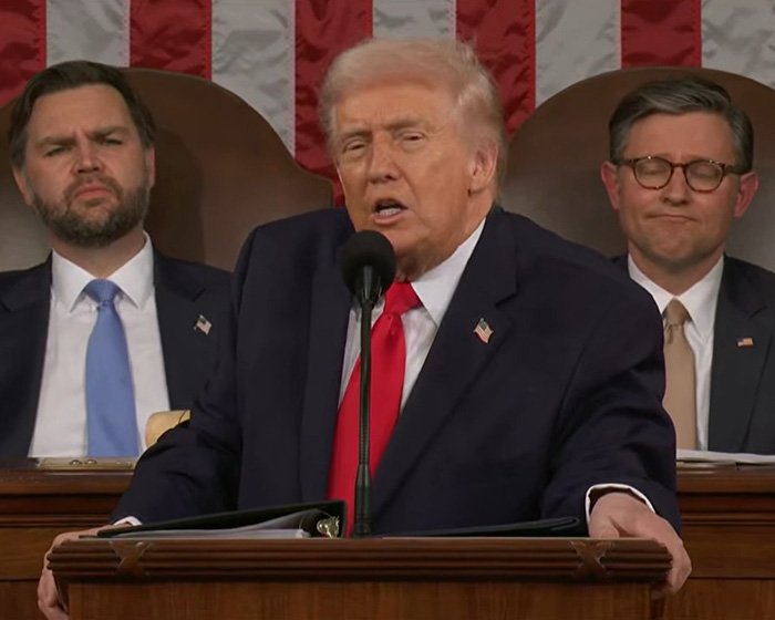 Donald Trump speaking at State of the Union with two men seated behind him, Erika Kirk goes viral mention context.