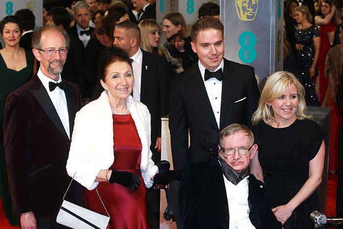 Stephen Hawking&rsquo;s family posing at a formal event, sparking comic reactions over Epstein files explanation.