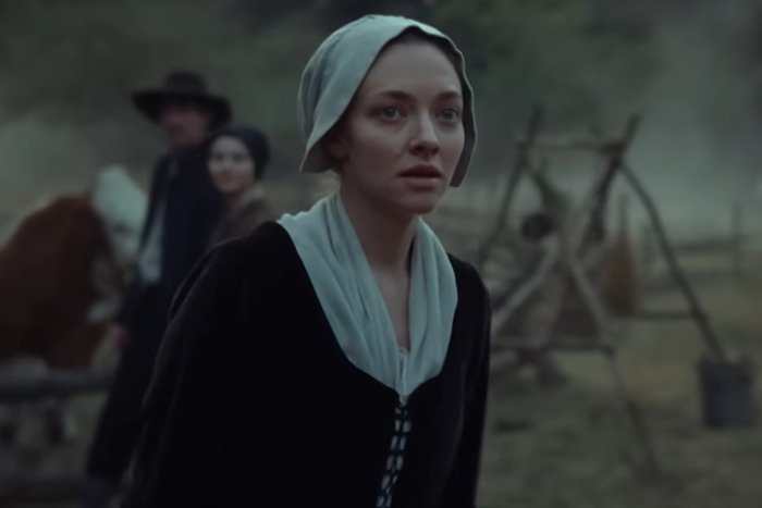 Amanda Seyfried in period costume on film set, discussing bizarre prosthetic worn for graphic scene in recent film.