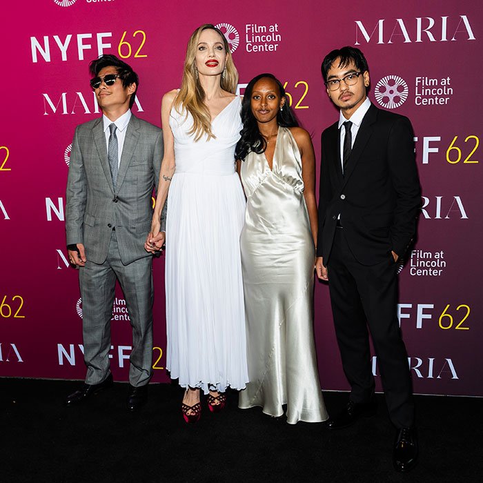 Four people posing at NYFF 62 Film at Lincoln Center event for Maria movie, relating to Brad Pitt kids relationship message.