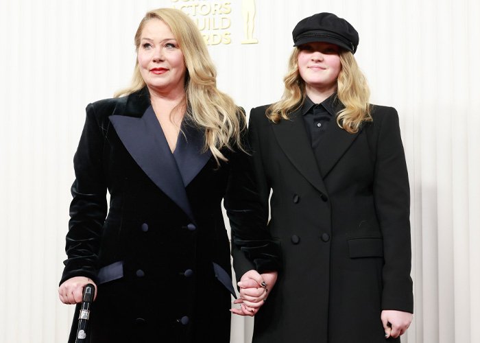 Christina Applegate and companion holding hands at an event, highlighting doctors breaking down ignored signs of MS.