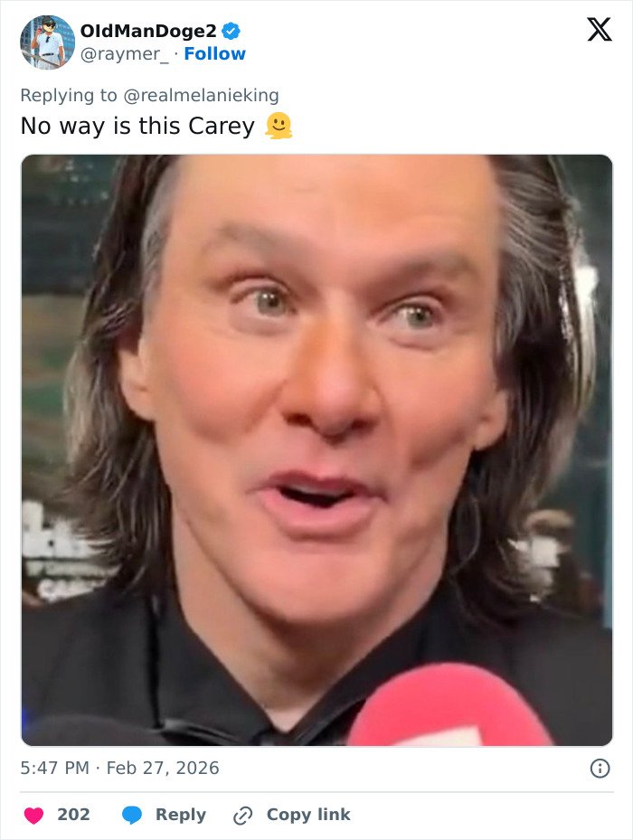 Close-up of man speaking to media with long hair, fans convinced something is off in viral Jim Carrey footage.