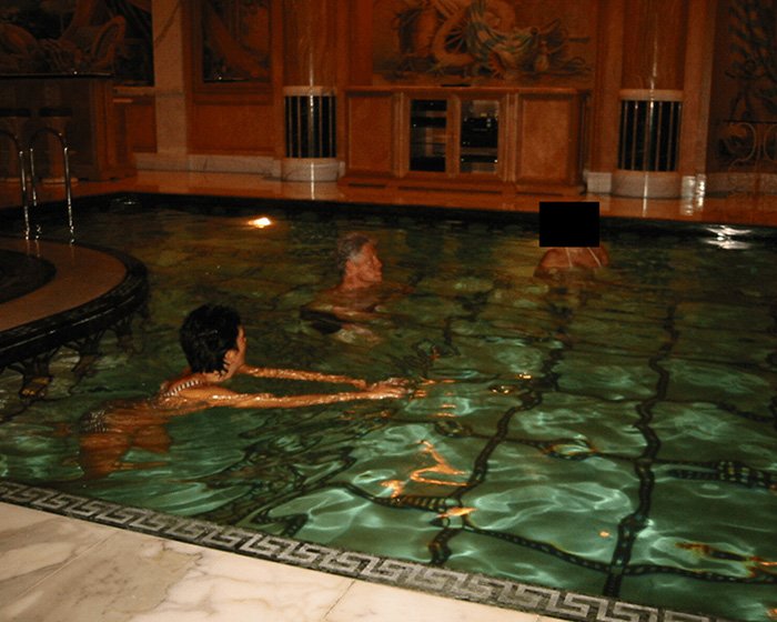 Bill Clinton swimming in an indoor pool with two other individuals, related to Epstein ties controversy.