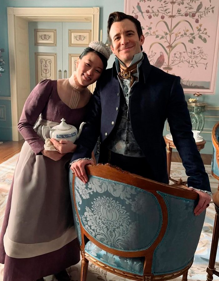 Bridgerton star smiling with co-actor in period costumes on set after steamy bathtub scene ended horribly.