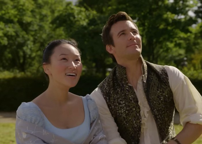 Bridgerton star and co-actor outdoors in period costumes during a sunny day scene for steamy bathtub moment aftermath.