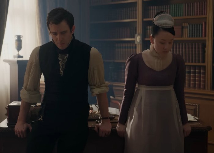 Bridgerton star and co-actor in period costumes in a tense library scene after steamy bathtub moment.