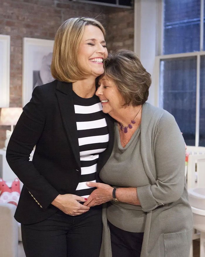 Two women smiling and embracing in a cozy room, illustrating a heartfelt moment related to Bitcoin exchange and police control.