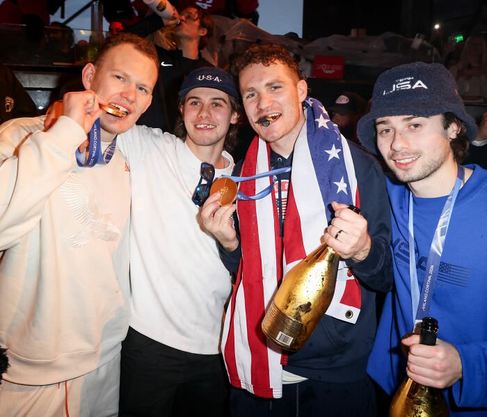 Team USA men's hockey players celebrating with medals and champagne, sparking controversy after White House visit.