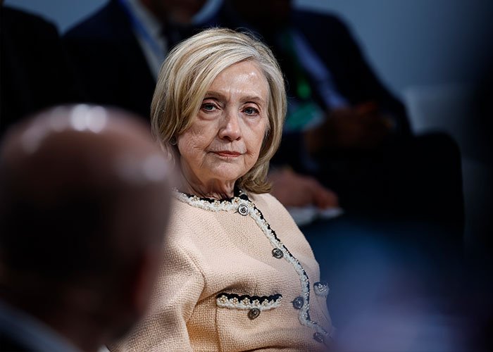 Hillary Clinton looking serious during a congressional clash discussing Epstein claims and Trump in a political setting.