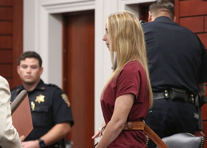 Woman in a courtroom standing with handcuffs, as a judge fires back at teacher after devastating outcome for student.