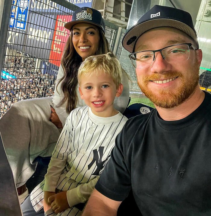 NASCAR driver smiling with his family at a sports event, highlighting interaction involving his 6-year-old son controversy.