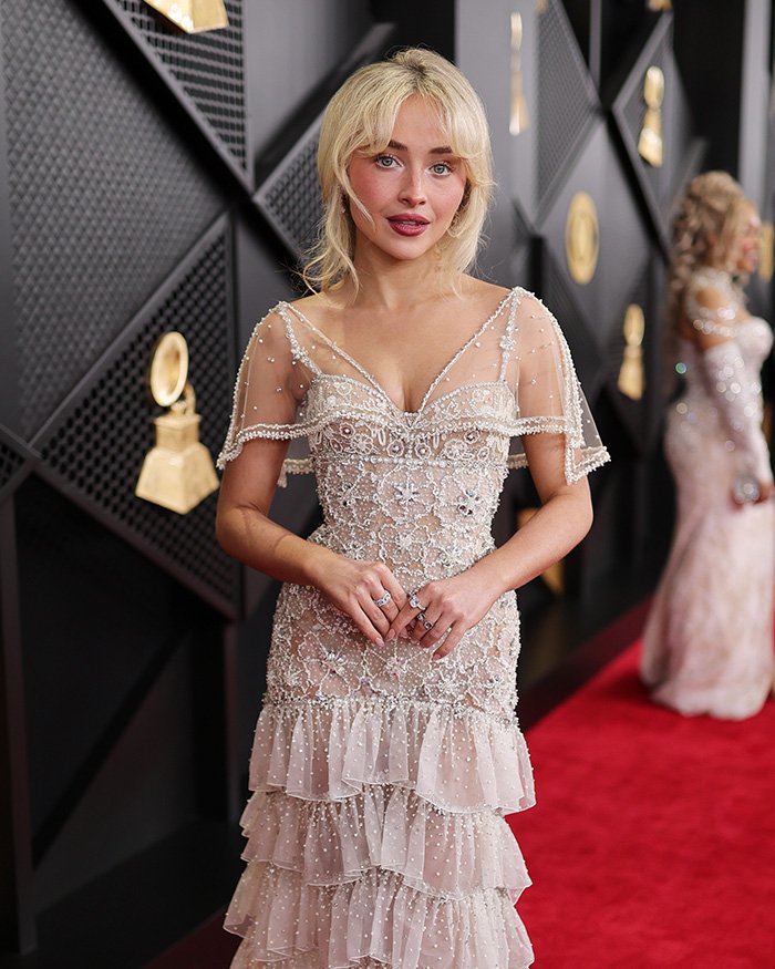Sabrina Carpenter on the red carpet, wearing an embellished dress, capturing fans&rsquo; attention with her Grammy loss reaction.