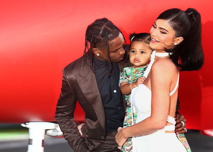 Travis Scott and Kylie Jenner with their child, facing criticism over the appalling kids birthday party theme.