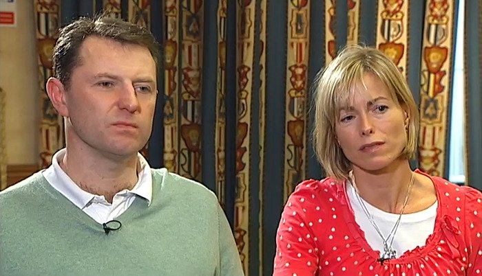 Couple with serious expressions sitting indoors during an interview about Madeleine McCann and Ghislaine Maxwell comparison debate.