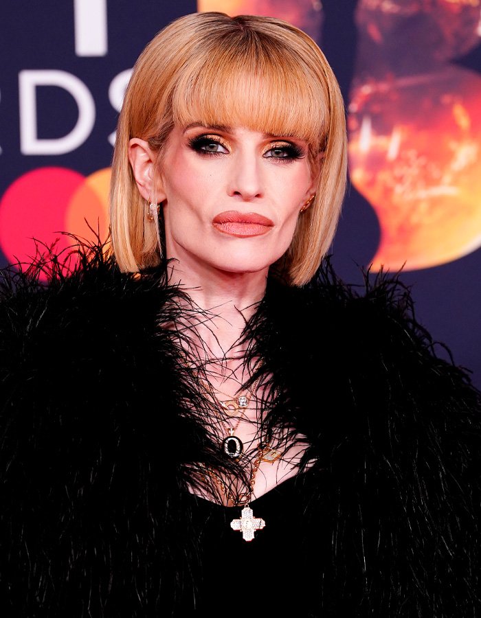 Kelly Osbourne with sharp facial features and blonde bob hairstyle at the Brit Awards, sparking buccal fat removal rumors.