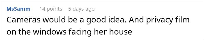 Man stressed and paranoid, sitting alone at desk with hands on head, facing an unhinged neighbor issue.